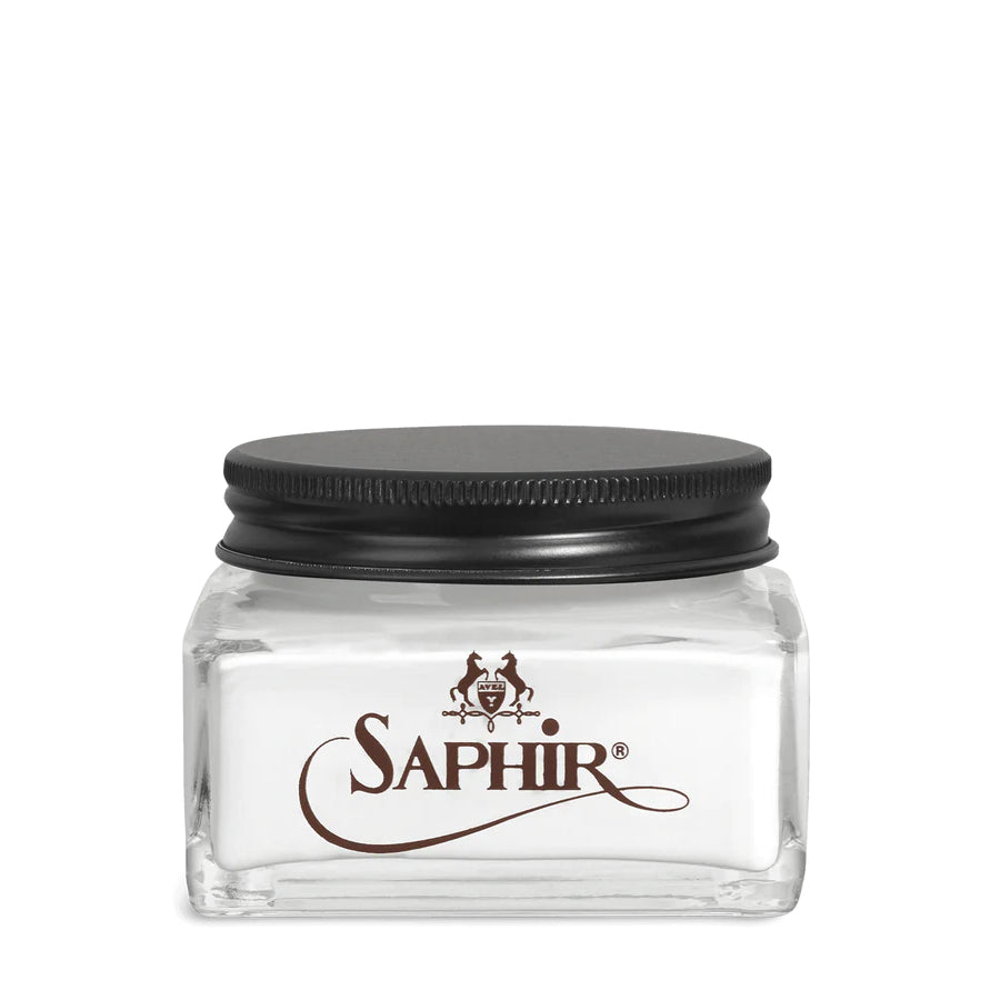 A glass jar with a black lid labeled 'SAPHIR' containing cream shoe polish.