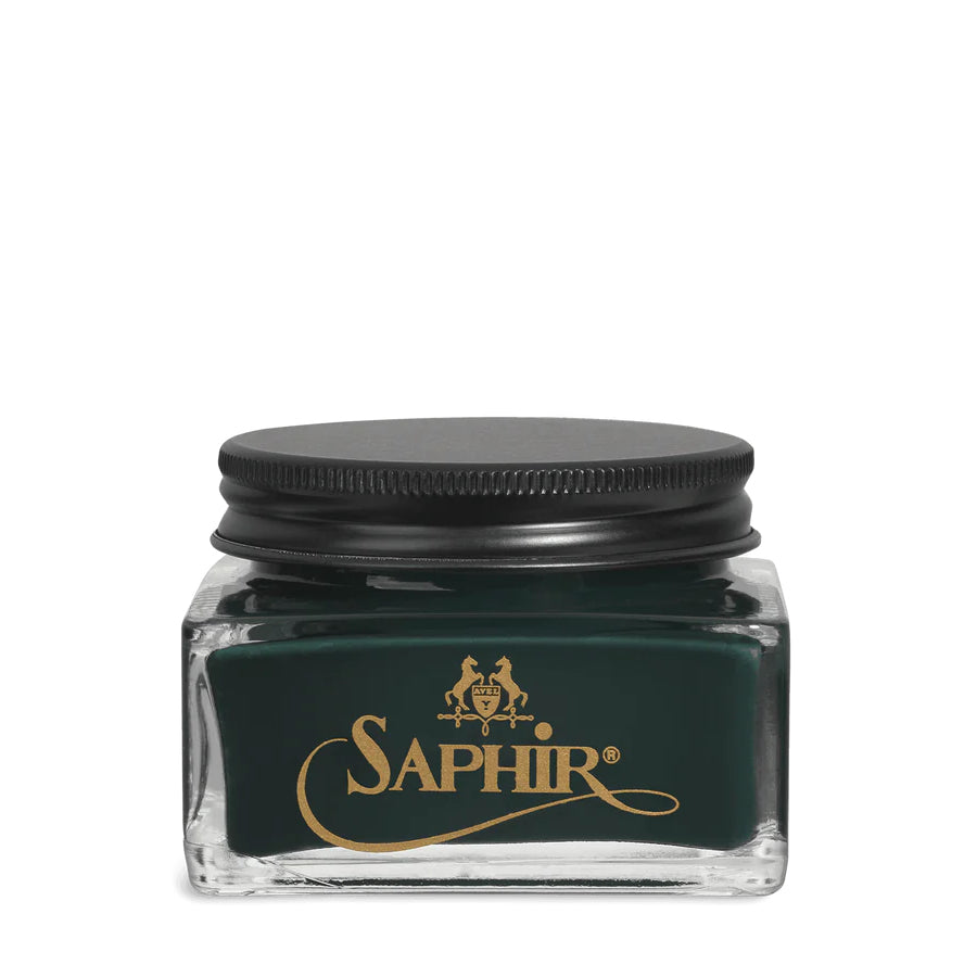 A glass jar with a black lid labeled 'SAPHIR' containing cream shoe polish.