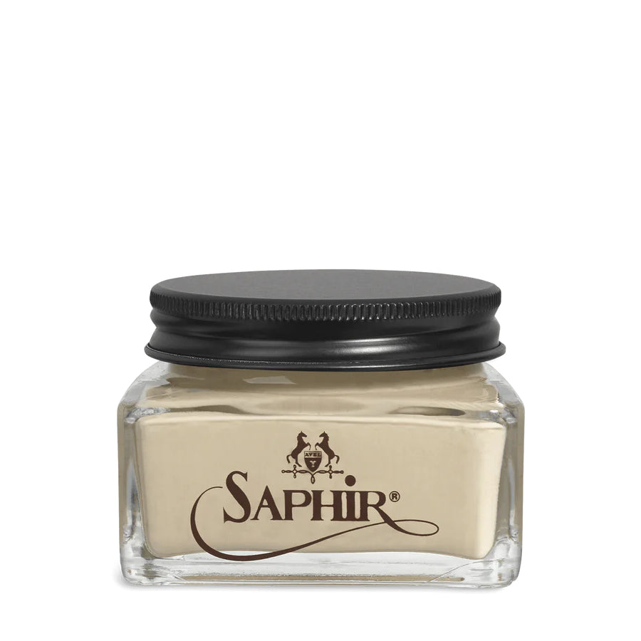 A glass jar with a black lid labeled 'SAPHIR' containing cream shoe polish.