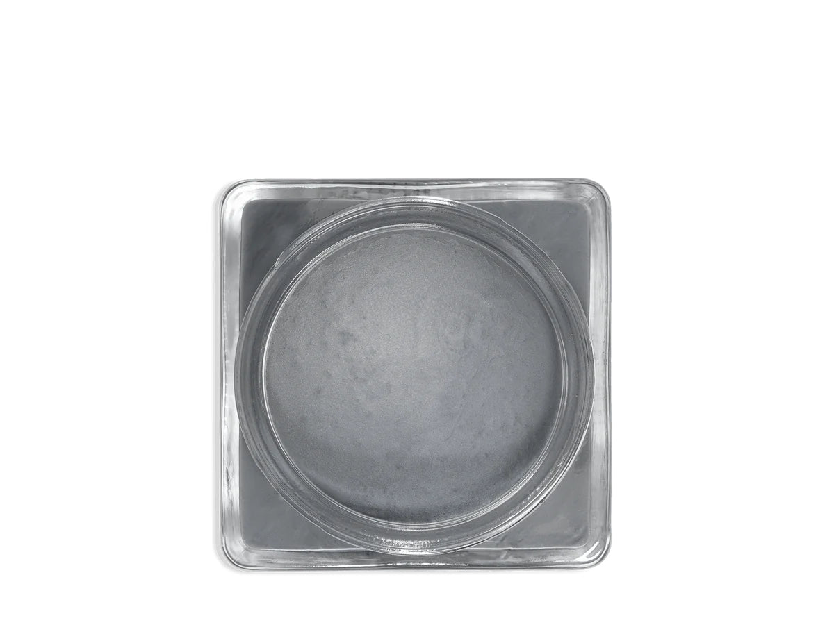 A glass jar 'SAPHIR' containing cream shoe polish.
