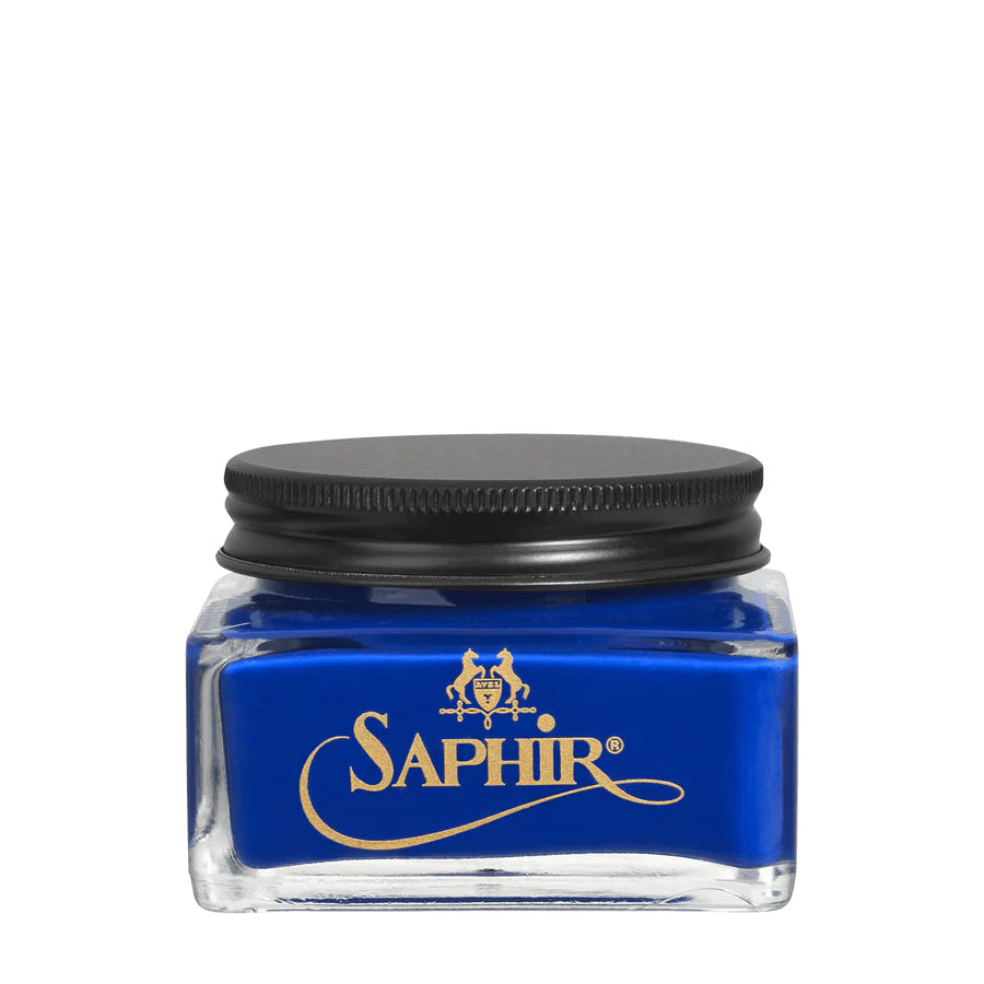 A glass jar with a black lid labeled 'SAPHIR' containing cream shoe polish.