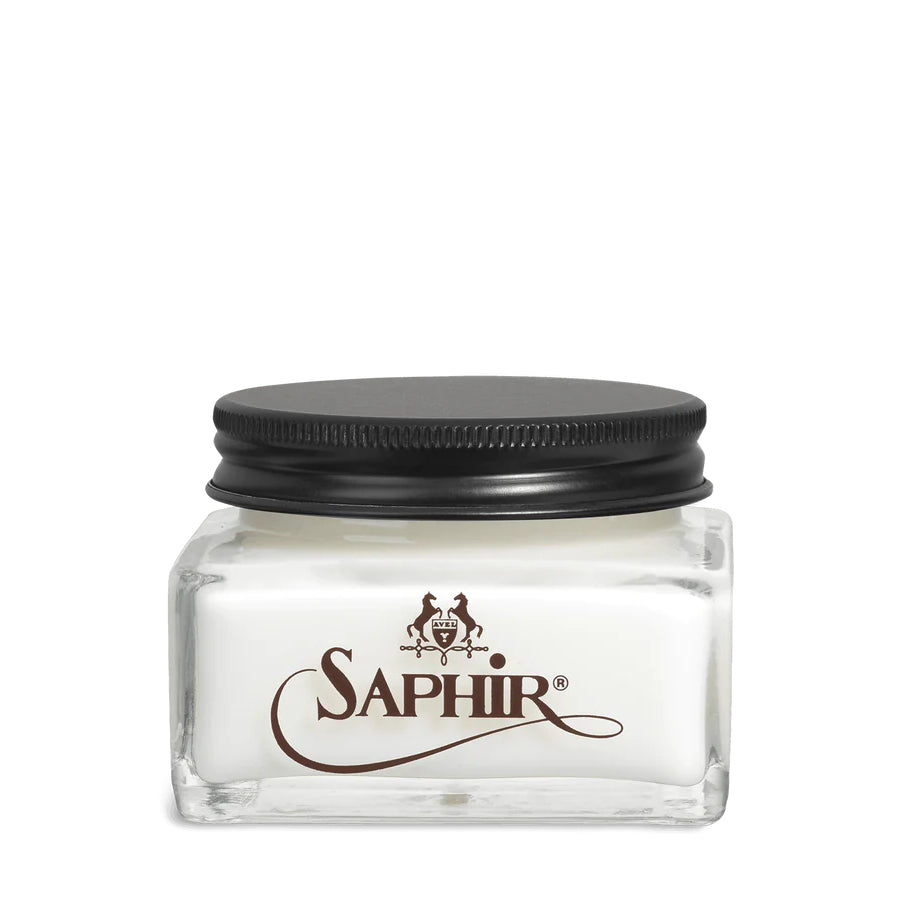 A glass jar with a black lid labeled 'SAPHIR' containing cream shoe polish.