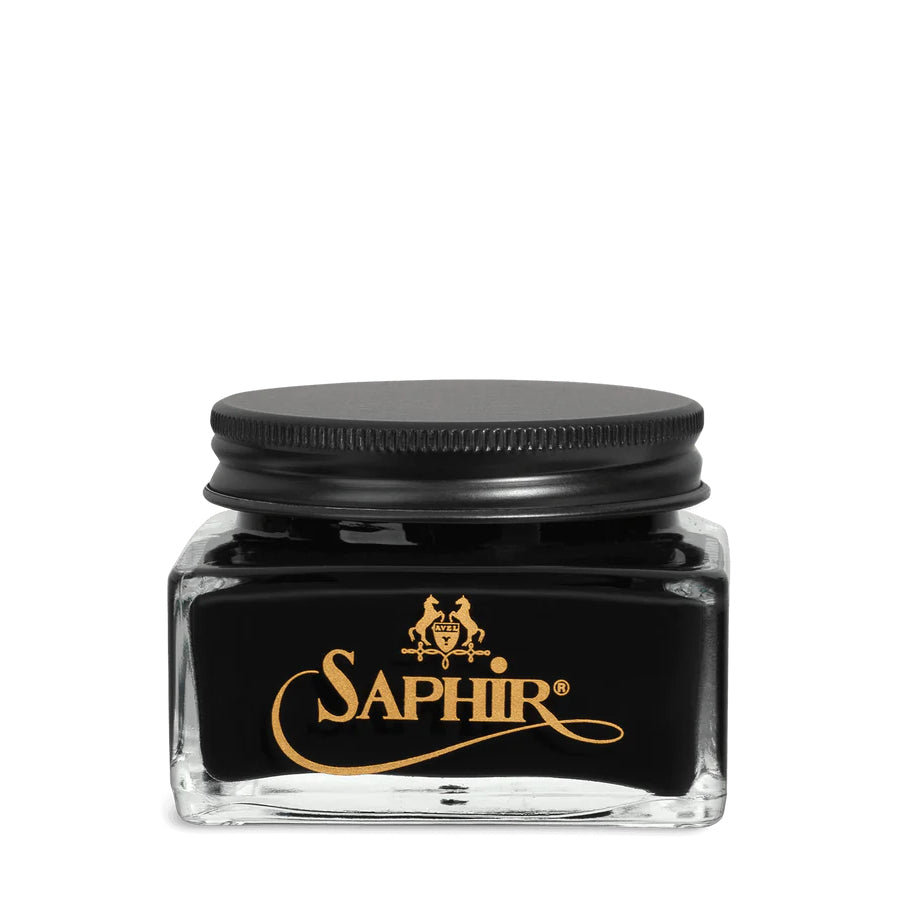 A glass jar with a black lid labeled 'SAPHIR' containing cream shoe polish.