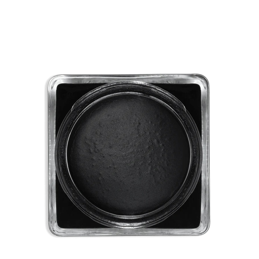 A glass jar with a black lid labeled 'SAPHIR' containing cream shoe polish.