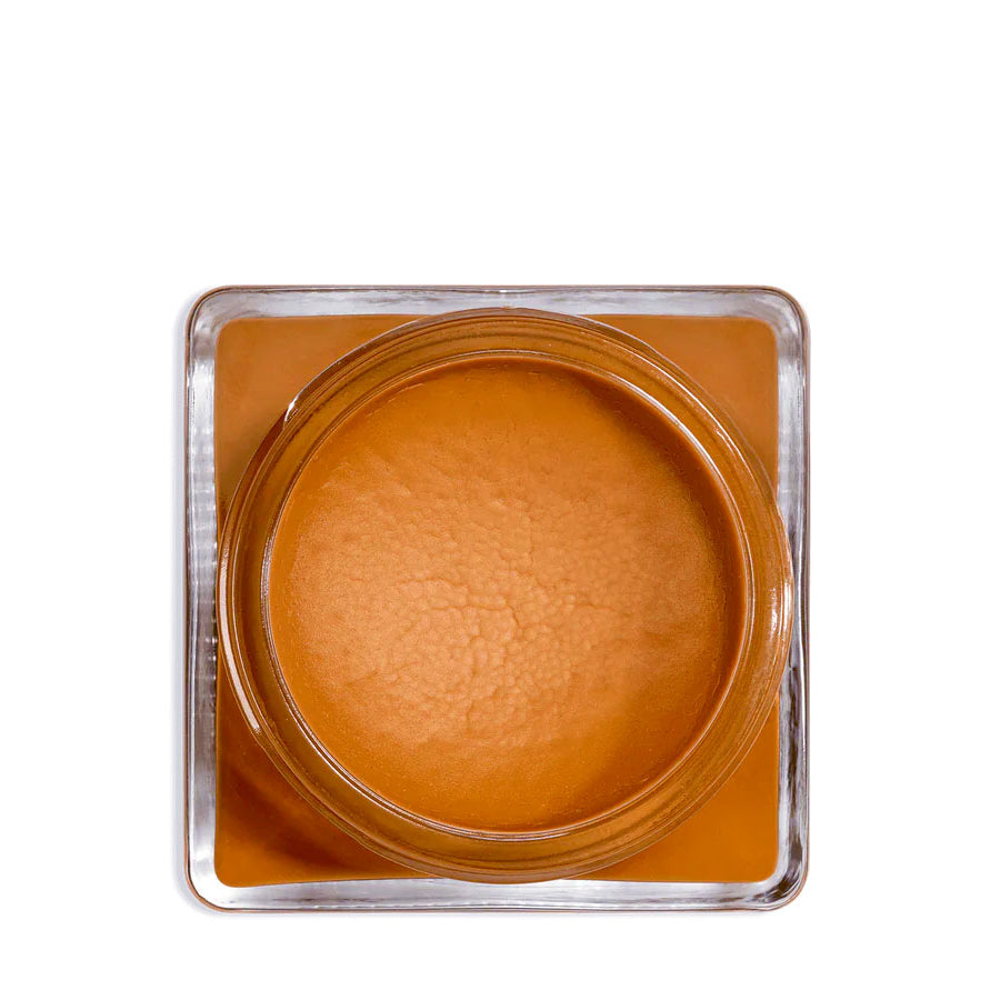 A glass jar 'SAPHIR' containing cream shoe polish.
