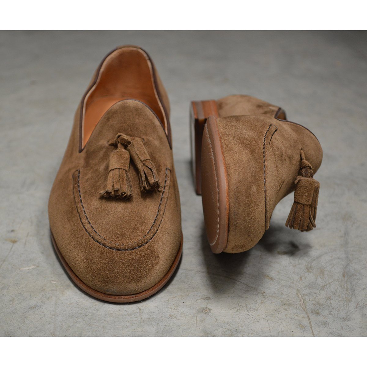 A brown suede tassel Berwick 1707 Belgian loafer with a combination leather and fine rubber sole.
