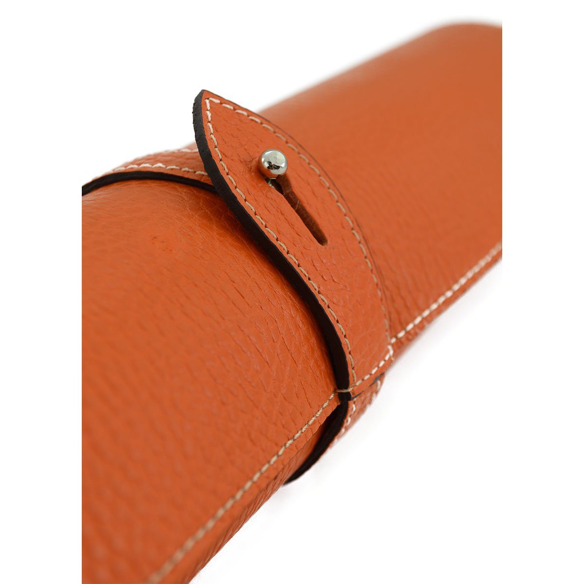 A Saphir Medaille D'Or rolled-up orange leather shoeshine mat with a nickel stud on the exterior.