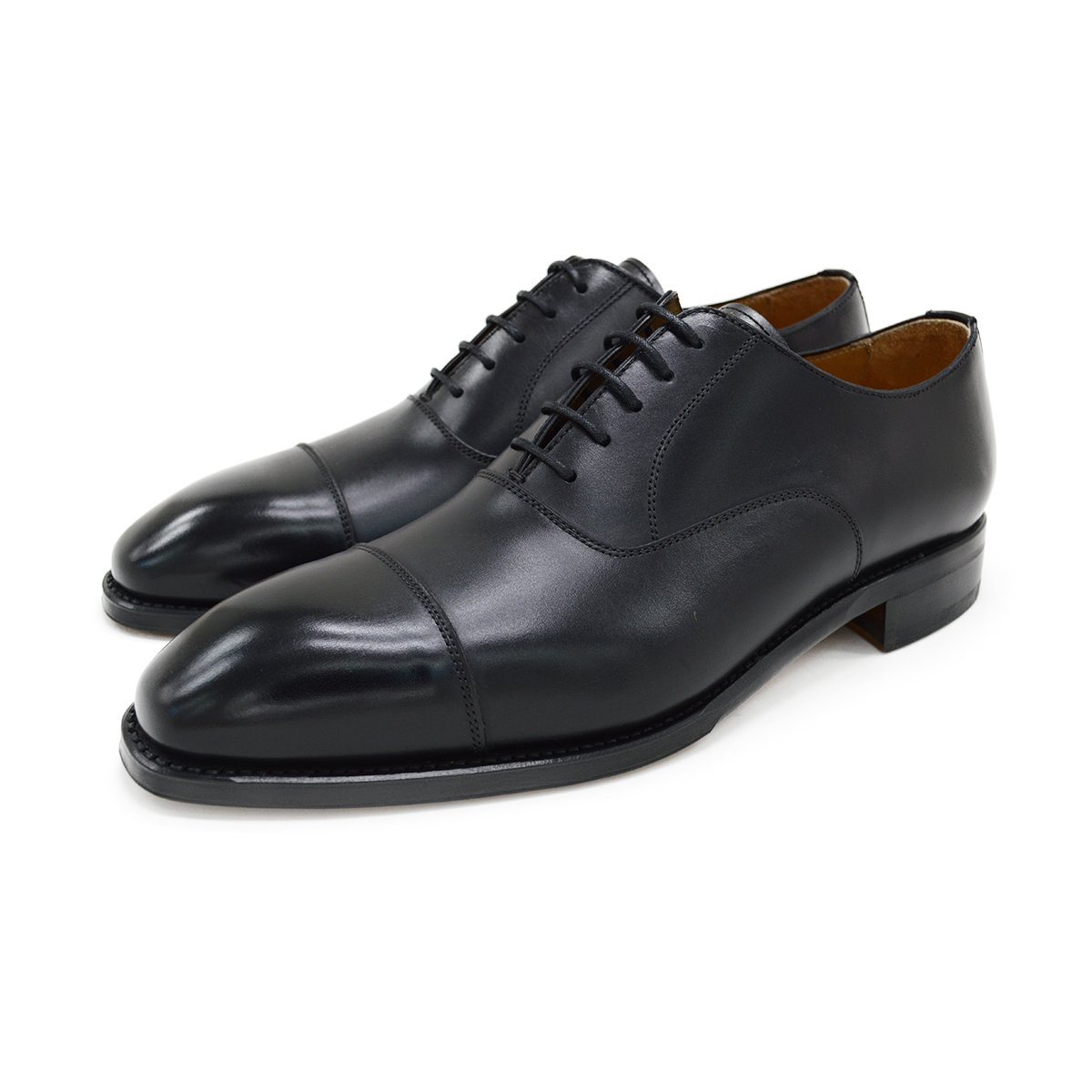 A black, boxcalf leather Oxford shoe with a chisel toe and lace-up closure, crafted in Spain.