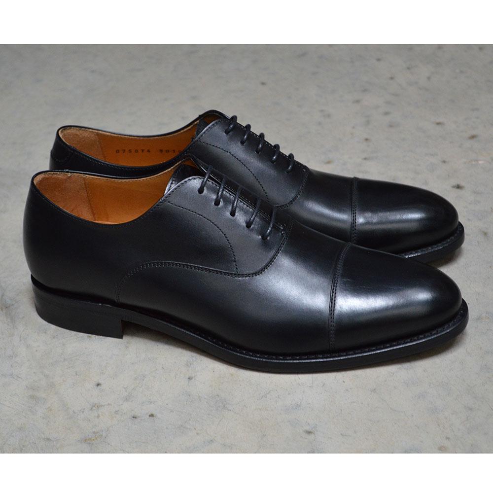 A Berwick 1707 black leather toe cap oxford shoe with a goodyear welted construction and single leather sole.