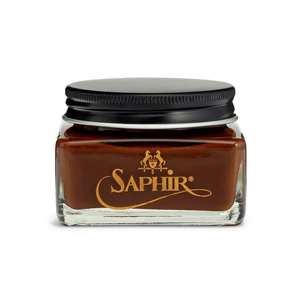 A glass jar with a black lid containing Saphir Medaille D'Or oiled leather cream, branded with the Saphir logo in gold lettering on a black label.