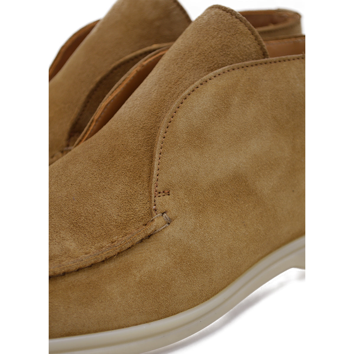 A brown ankle boot made of reverse kudu suede, featuring a low heel and a smooth texture.