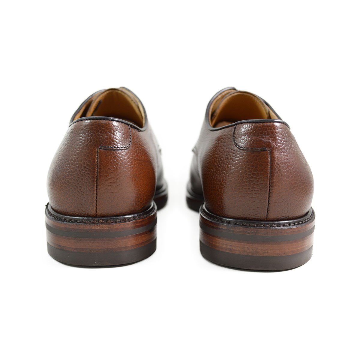 A dark brown, grainy-textured leather derby shoe with a round toe and classic lace-up closure & Dainite soles