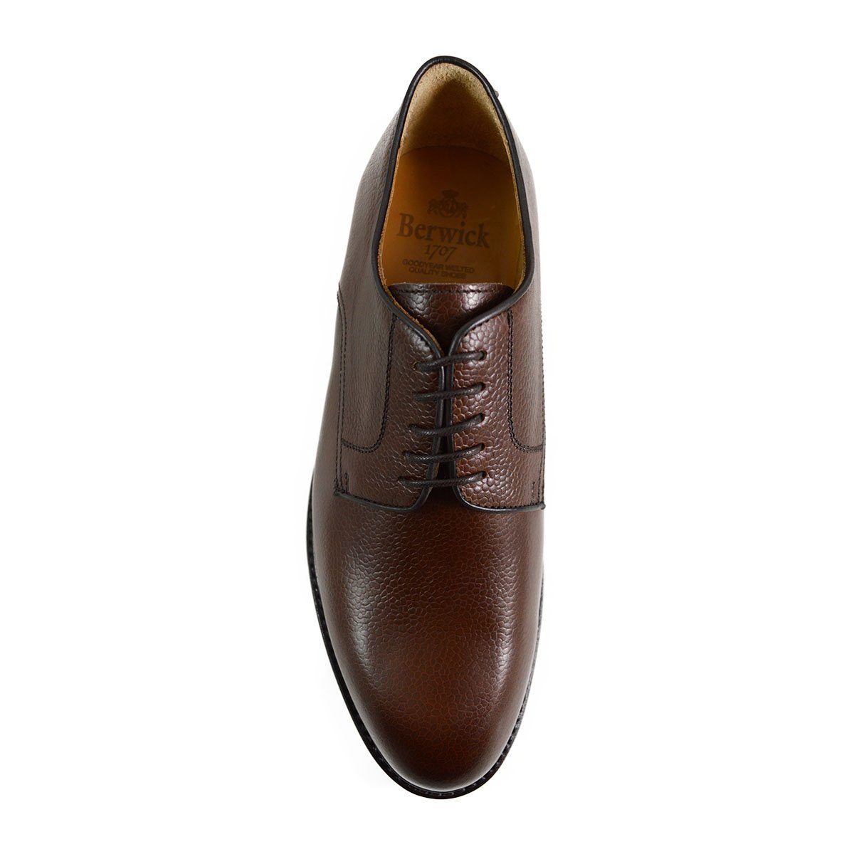 A dark brown, grainy-textured leather derby shoe with a round toe and classic lace-up closure & Dainite soles