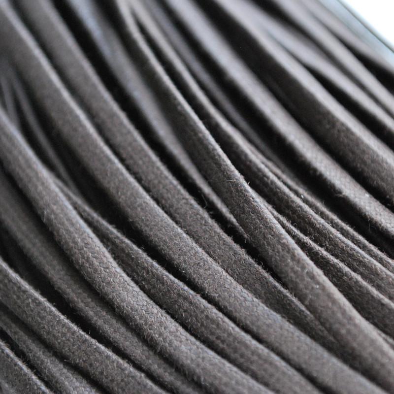 A close-up view of dark brown or black flat waxed cotton shoe laces, 3mm wide and 800mm long.