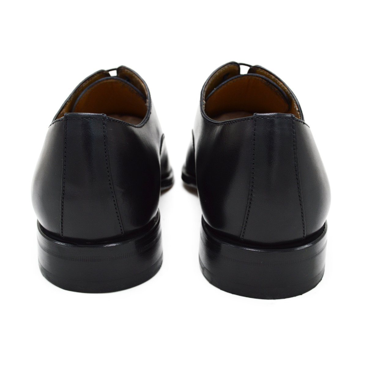 A black, boxcalf leather Oxford shoe with a chisel toe and lace-up closure, crafted in Spain.