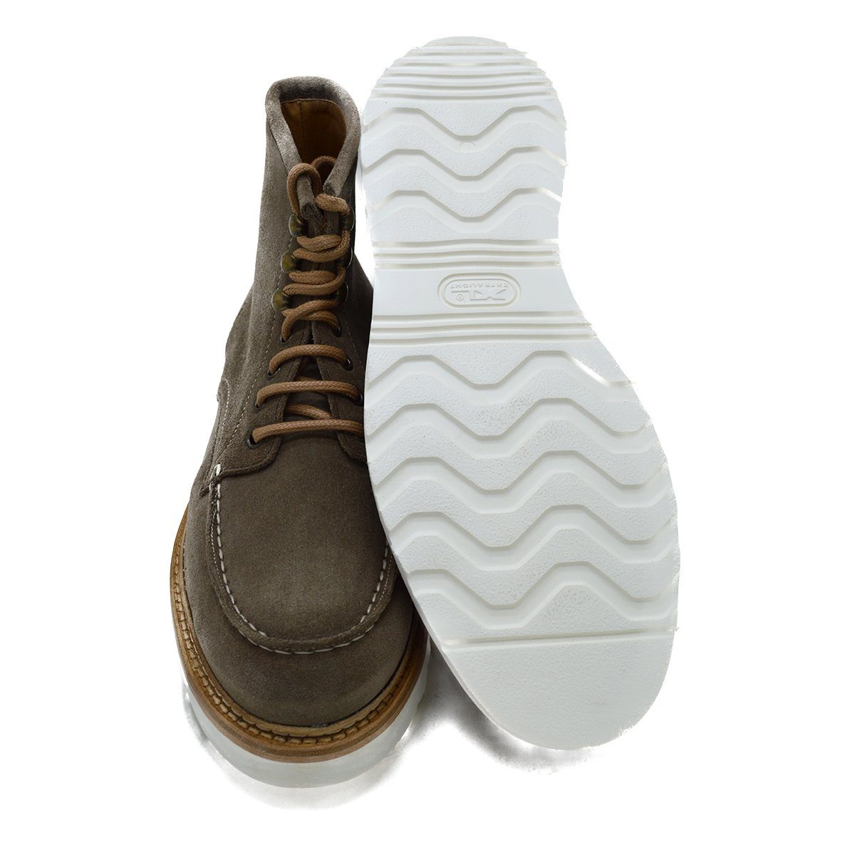 A grey and tan suede apron boot with lace-up closure, featuring a white sole and a natural welt.