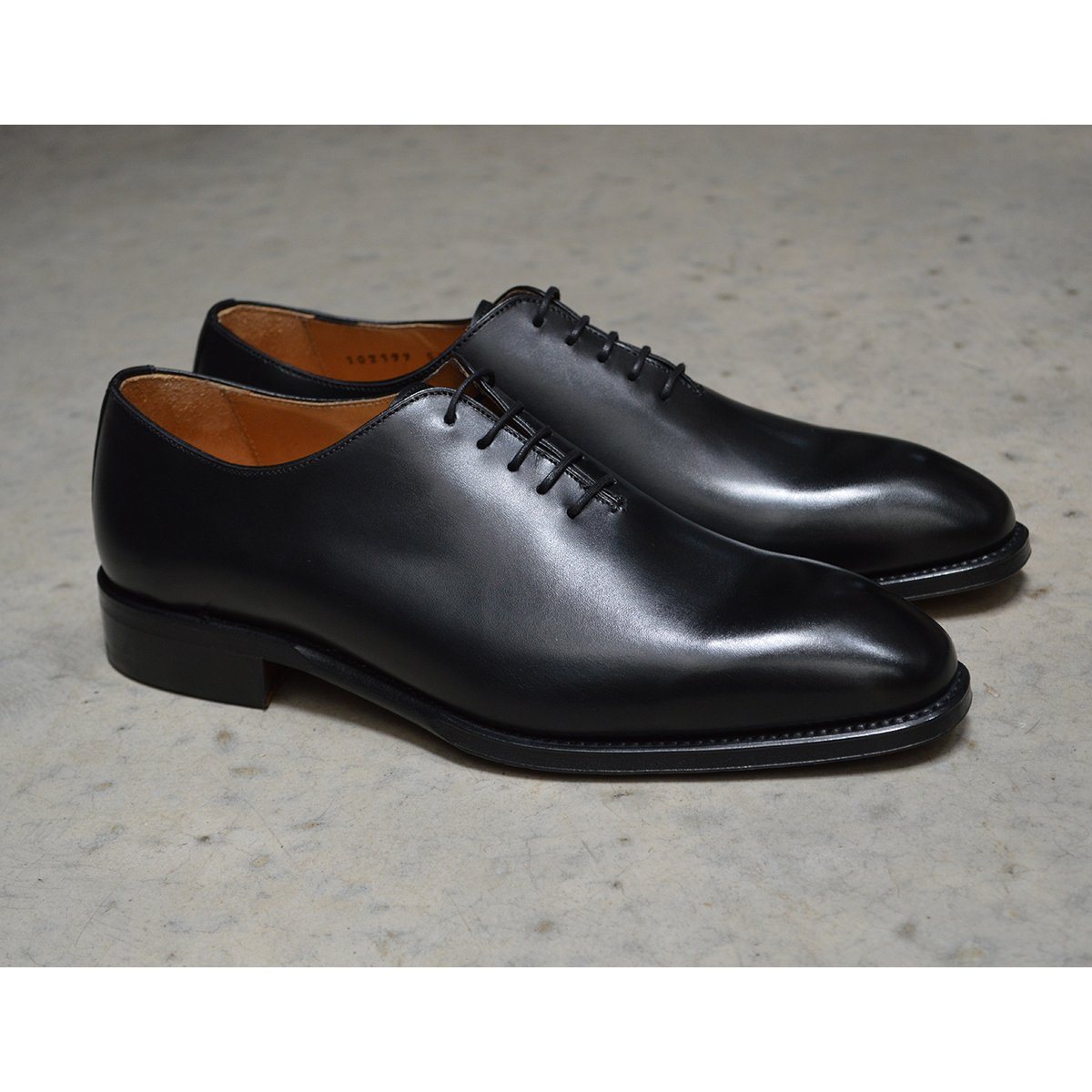 A Berwick 1707 black leather Oxford shoe with a wholecut design and lace-up closure, side view.