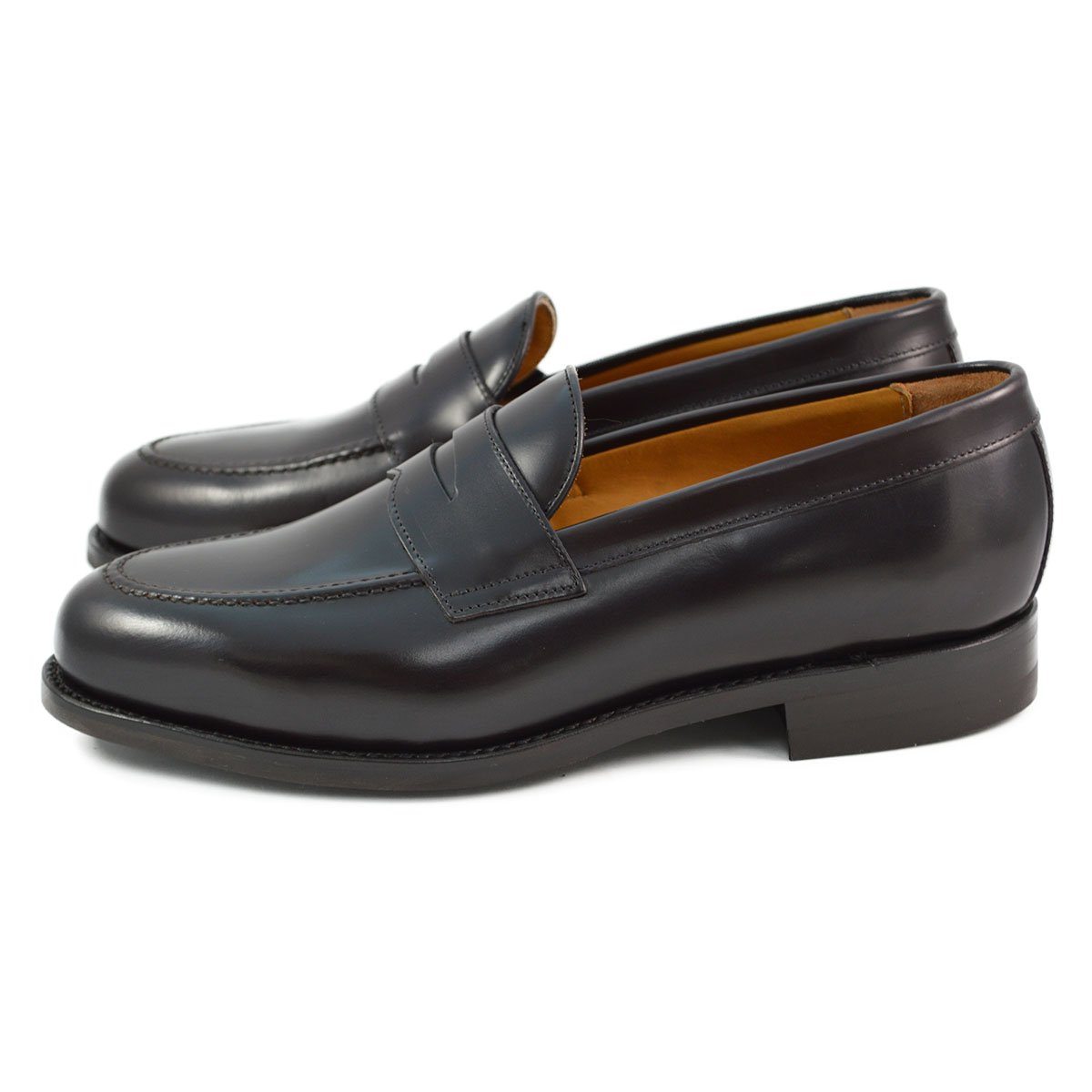 A dark brown Berwick 1707 Penny Loafer with a high-shine finish and a Dainite rubber sole.