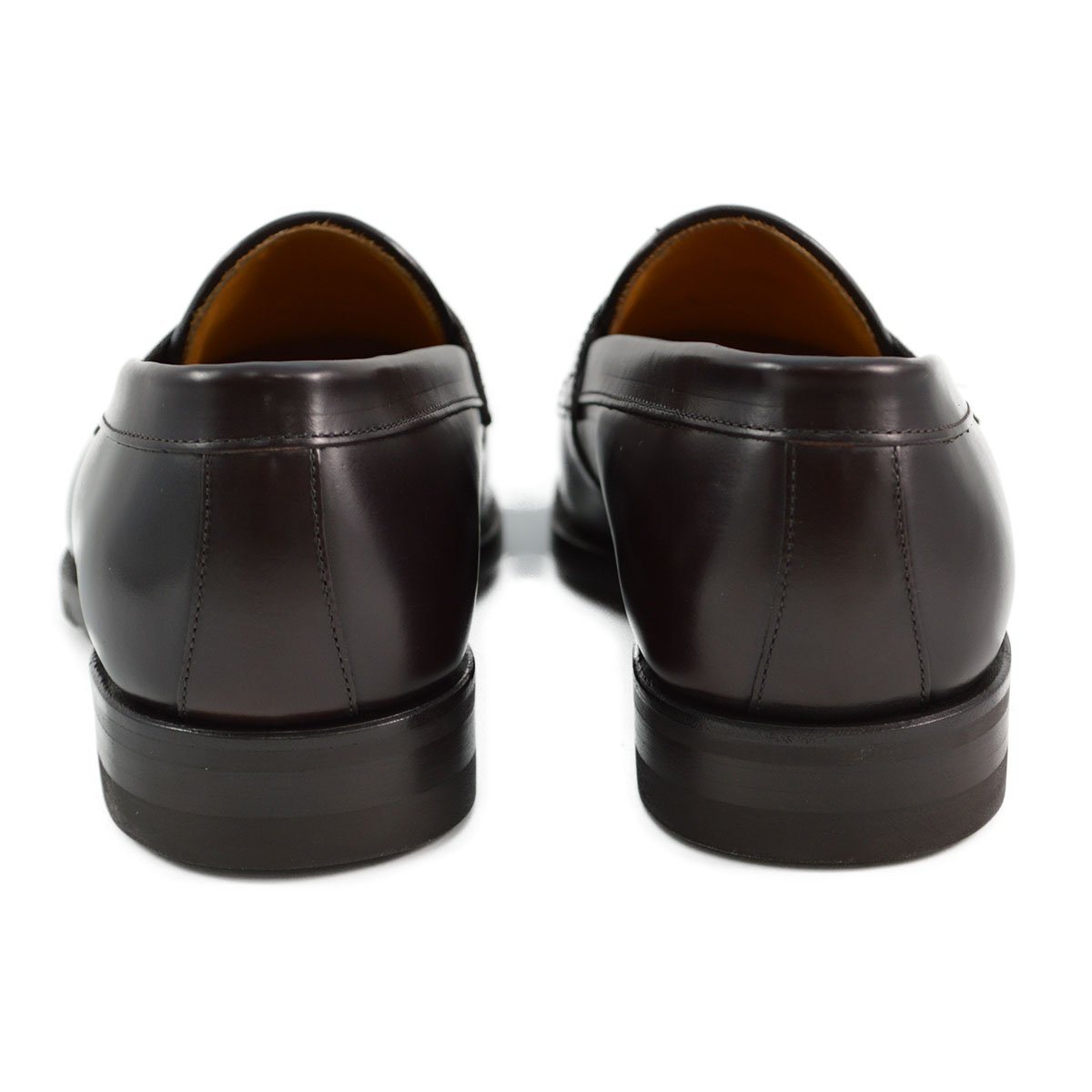 A dark brown Berwick 1707 Penny Loafer with a high-shine finish and a Dainite rubber sole.