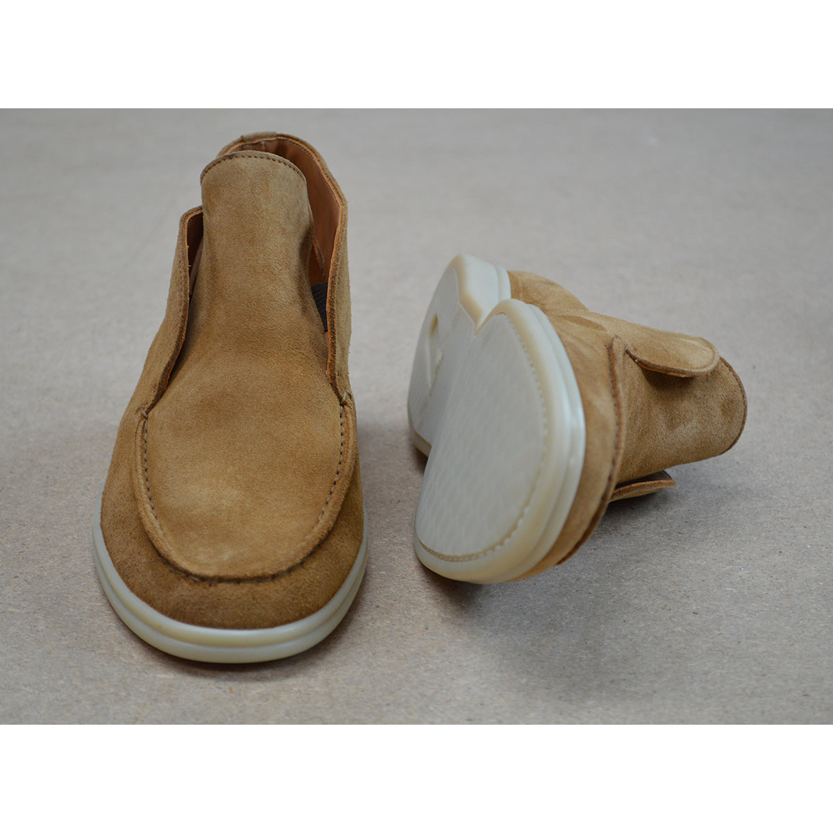 A brown ankle boot made of reverse kudu suede, featuring a low heel and a smooth texture.