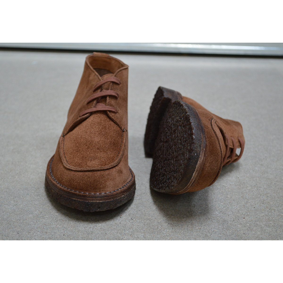 A brown Berwick 1707 5432 Apron Boot with lace-up closure, handcrafted from reverse kudu suede, featuring moccasin stitching and a crepe rubber sole.