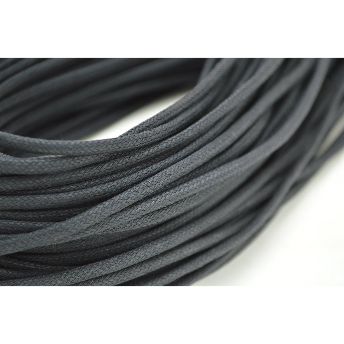 A close-up image of a dark brown waxed shoelace with a focus on its texture and weave.