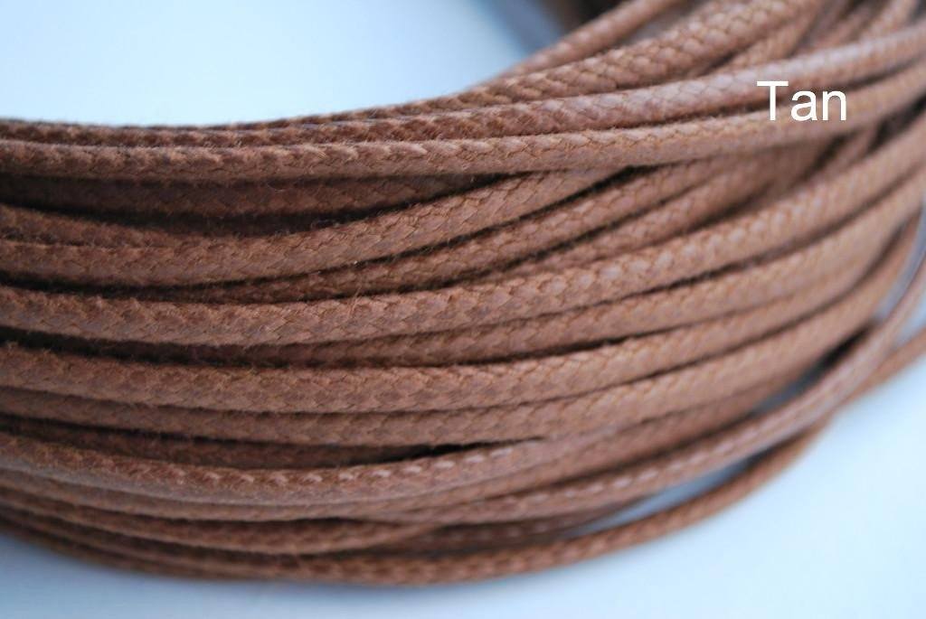 A close-up image of a waxed round brown shoe lace.