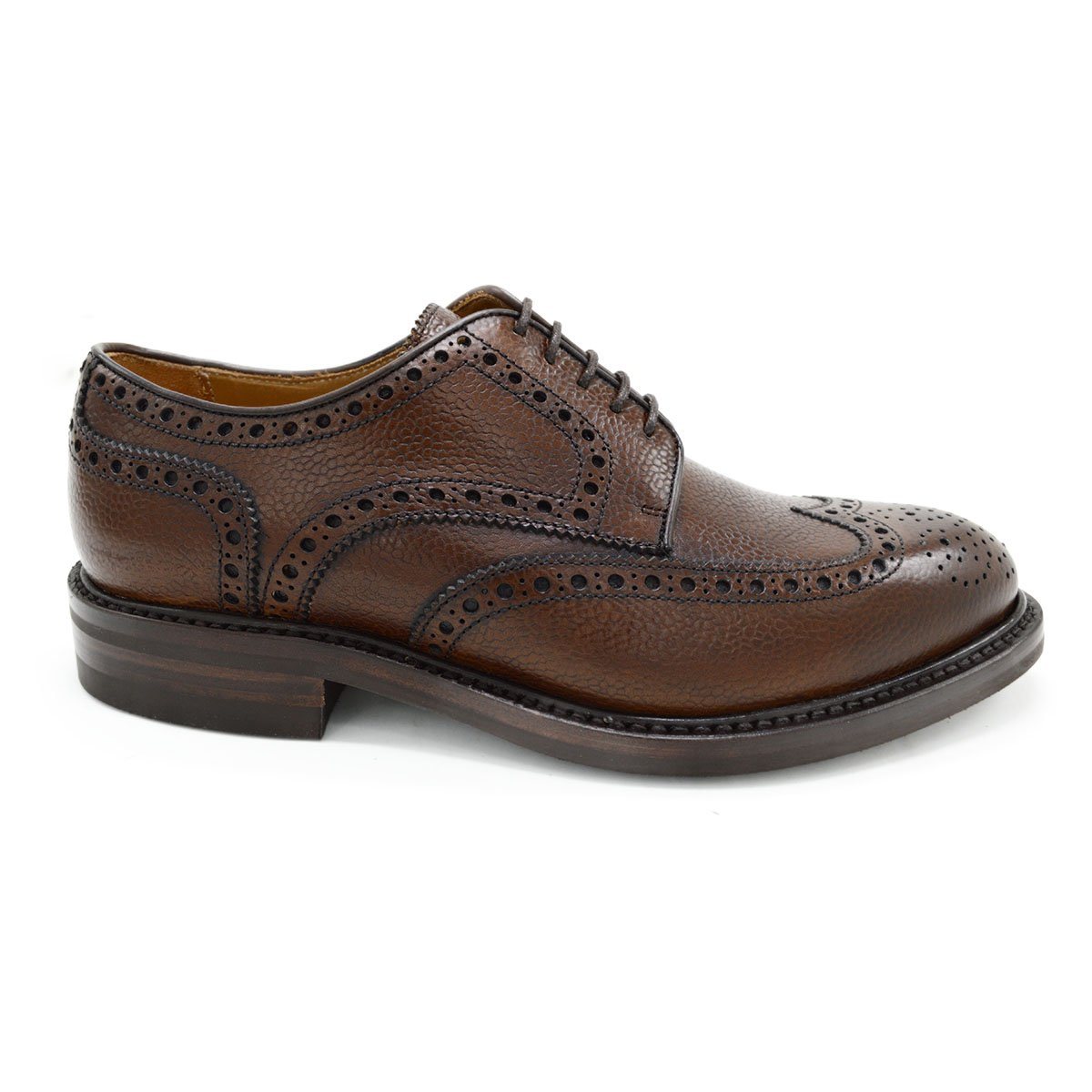 A Berwick 1707 brown brogue derby shoe with a round toe shape and lace-up closure. It features a grainy texture and brogue detailing & Dainite soles