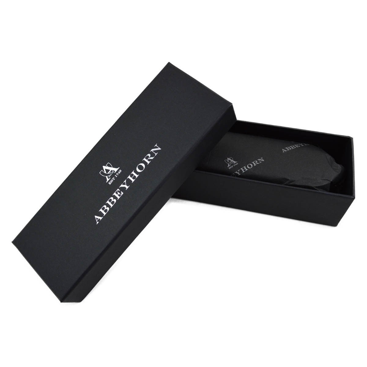 A handcrafted shoe polishing brush with a black and white oxhorn handle and dark bristles, presented on a plain background.
