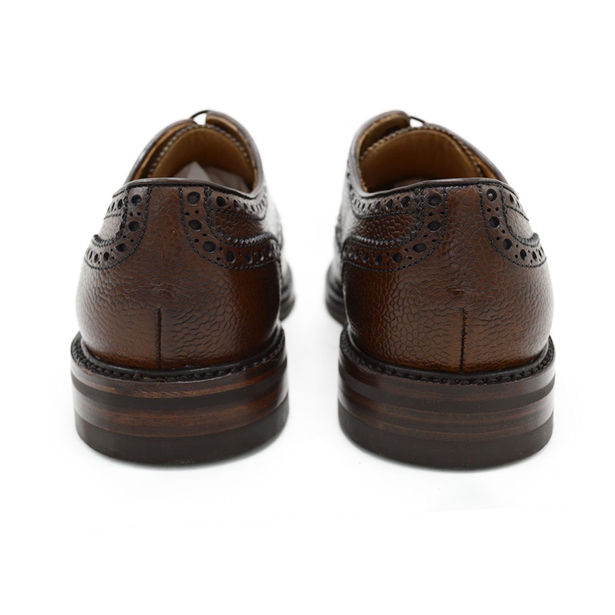 A Berwick 1707 brown brogue derby shoe with a round toe shape and lace-up closure. It features a grainy texture and brogue detailing & Dainite soles
