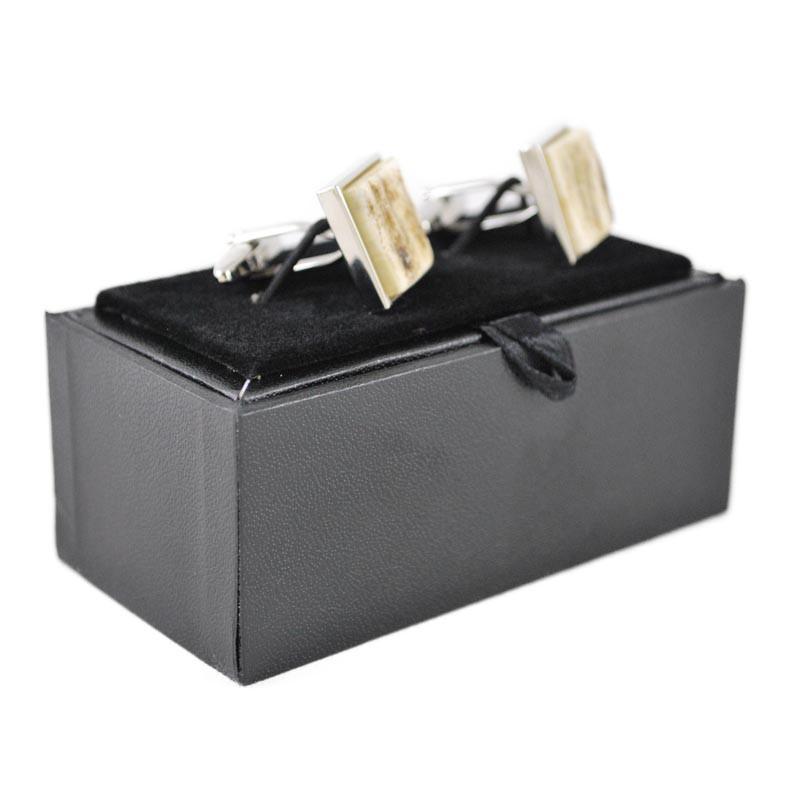 A pair of square cufflinks with stag antler inlays, mounted on a white background.