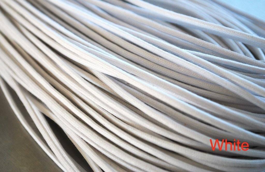 A close-up of a white waxed round dress shoe lace.