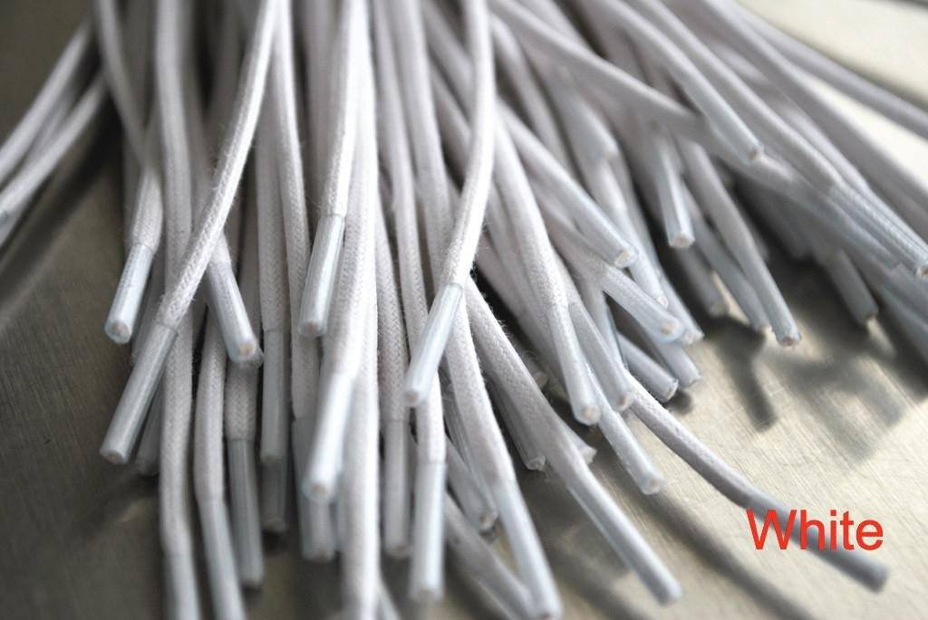 A close-up of white waxed round dress shoe laces