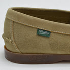 Close-up of a green suede shoe with 'Paraboot' branding on a white background