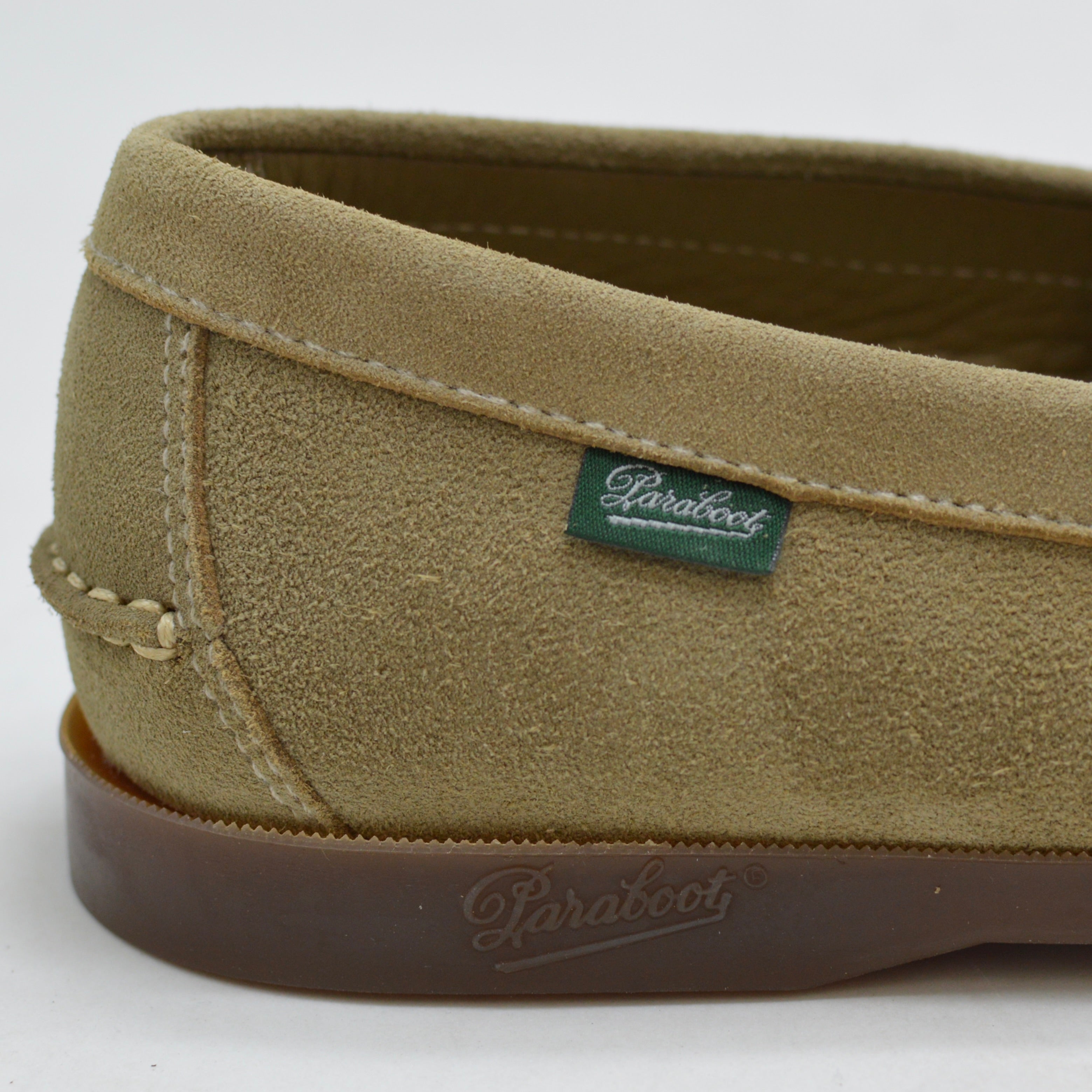 Close-up of a green suede shoe with 'Paraboot' branding on a white background