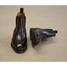 A dark brown leather Chelsea boot with a side pull tab and a low heel & Dainite soles