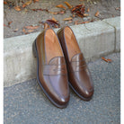 Berwick 1707 Brown leather loafer shoe on a concrete kerb background 