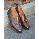 A Berwick 1707 brown tasseled loafer shoe with a closed toe and leather sole.