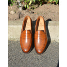 Berwick 1707 Brown tan leather loafer shoe on a polished concrete curb with Dainite Soles