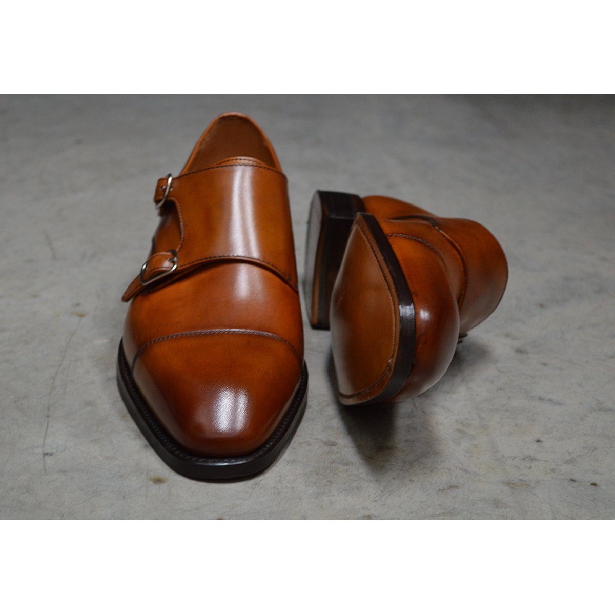 A brown double monk strap shoe with a polished leather upper and a Goodyear welted sole.