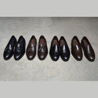 A classic black & brown Berwick 1707 Belgian loafer with a smooth deerskin leather upper, an almond toe shape, and a low heel.