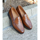 Berwick 1707 Brown tan leather loafer shoe on a polished concrete curb with Dainite Soles