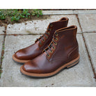 A brown leather service boot with a dainite sole and brass eyelets, designed for the forestry industry.