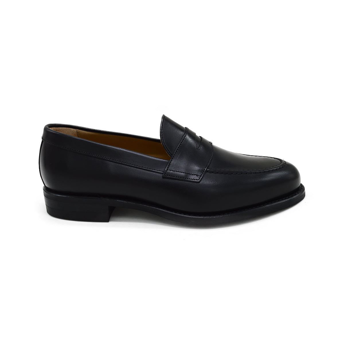 A black calf leather penny loafer with a Dainite rubber sole, showing a classic round toe shape and the iconic penny slot detail.