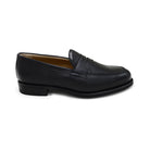 A black deerskin Penny loafer with a velvety soft texture and a classic round toe, set against a white background.