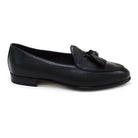 A black deerskin leather tassel Belgian loafer with an almond-shaped toe and a subtle tread sole, displayed against a white background.