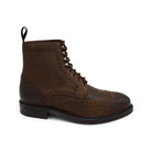 A dark brown lace-up brogue boot with a rubber sole and visible stitching on the upper part.