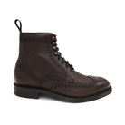 A Berwick 1707 dark brown brogue boot with a lace-up closure, round toe shape, and a Dainite rubber sole.