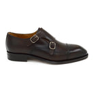 A Berwick 1707 lack double monk shoe with two buckle straps, made from calf leather and featuring a Goodyear welted leather sole.