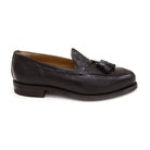 A Berwick 1707 dark brown deerskin slip-on loafer with a tassel detail on the vamp & Dainite sole, displayed on a plain background